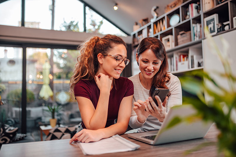 Two women looking at a laptop screen